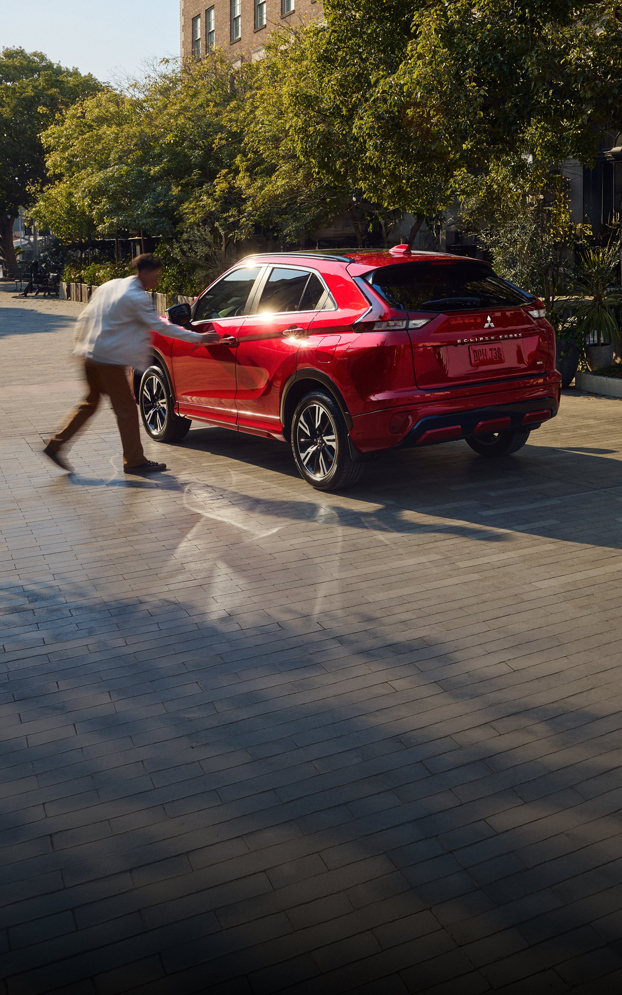 Angled back view of a red 2026 Mitsubishi Eclipse Cross compact SUV