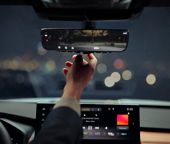 Close up on the rearview mirror in the 2026 Mitsubishi Outlander SUV showing Homelink Garage Door Integration