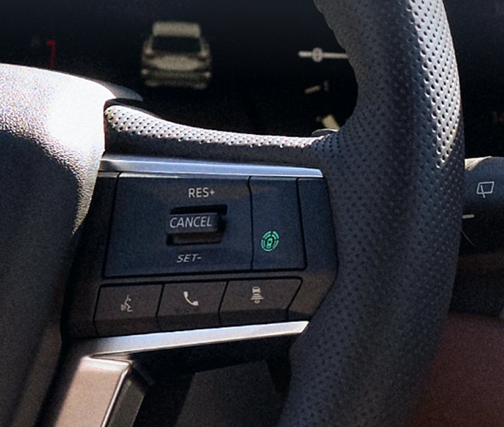 Close up on the traffic jam assist controls on the steering wheel of the 2026 Mitsubishi Outlander SUV