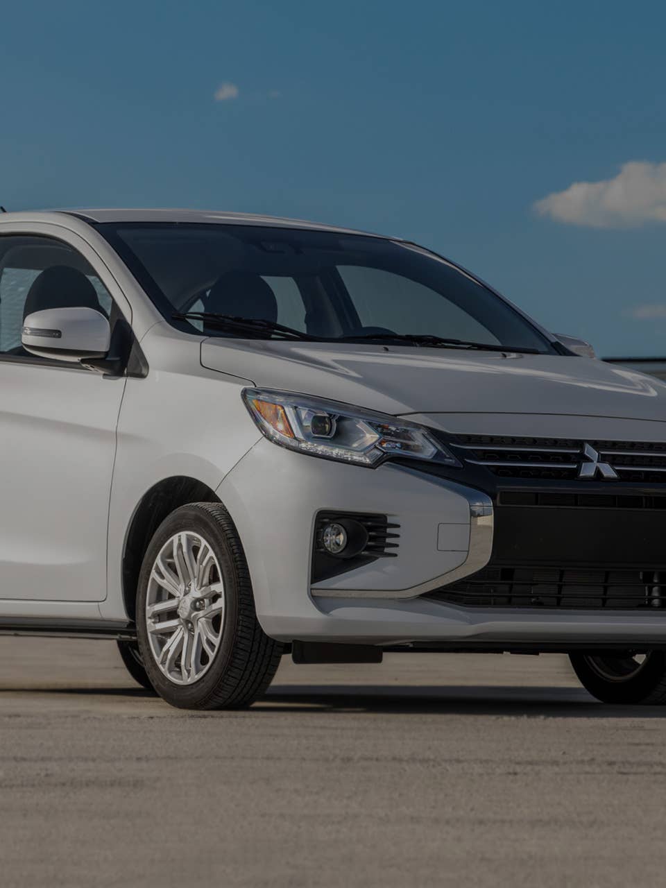 https://www.mitsubishicars.com/content/dam/mitsubishi-motors-us/images/siteimages/cars/mirage-g4/my23/overview/2023-mitsubishi-sedan-white-parked-front-side-view-m.jpg?width=960&auto=webp&quality=70