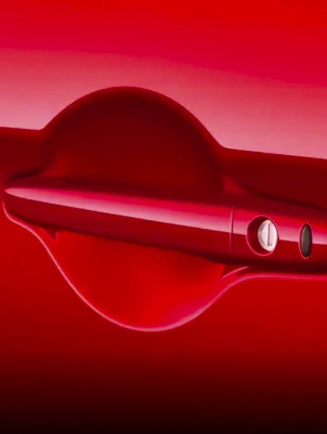 Close up on red 2026 Mitsubishi Outlander Sport SUV door handle