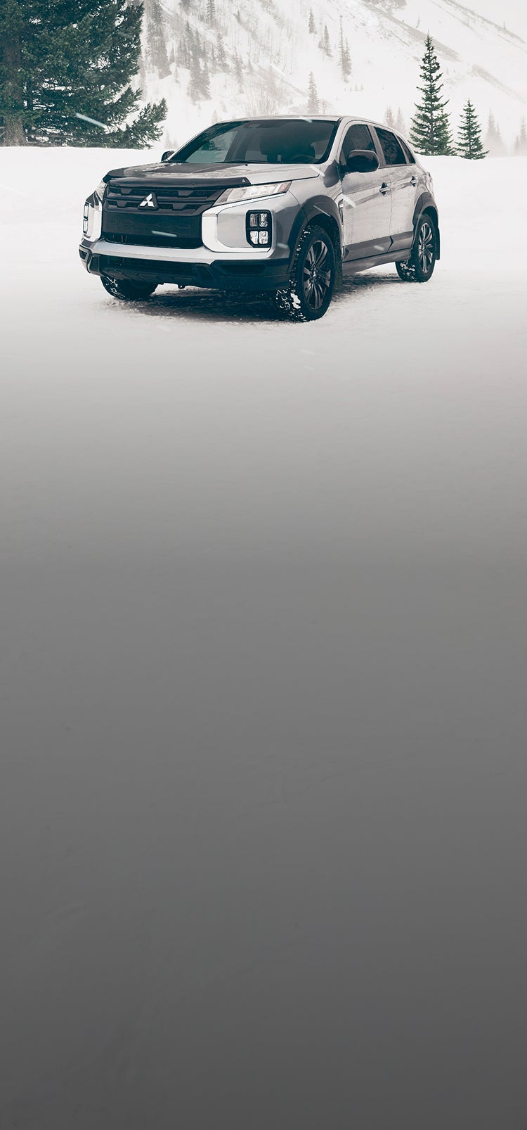 A silver 2025 Mitsubishi Outlander Sport SUV in the snow