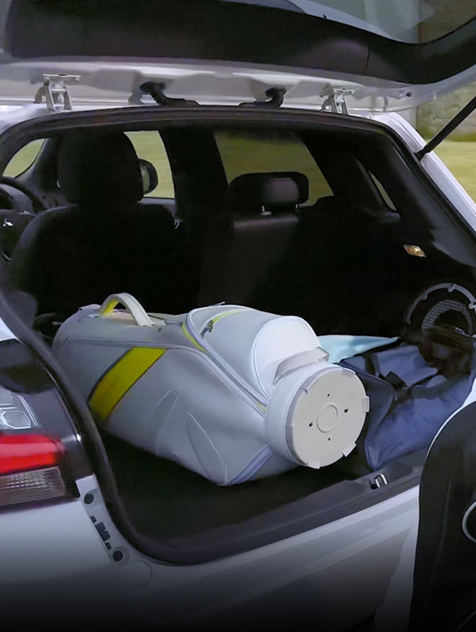 White golf bag and other containers in trunk of 2026 Mitsubishi Outlander Sport SUV