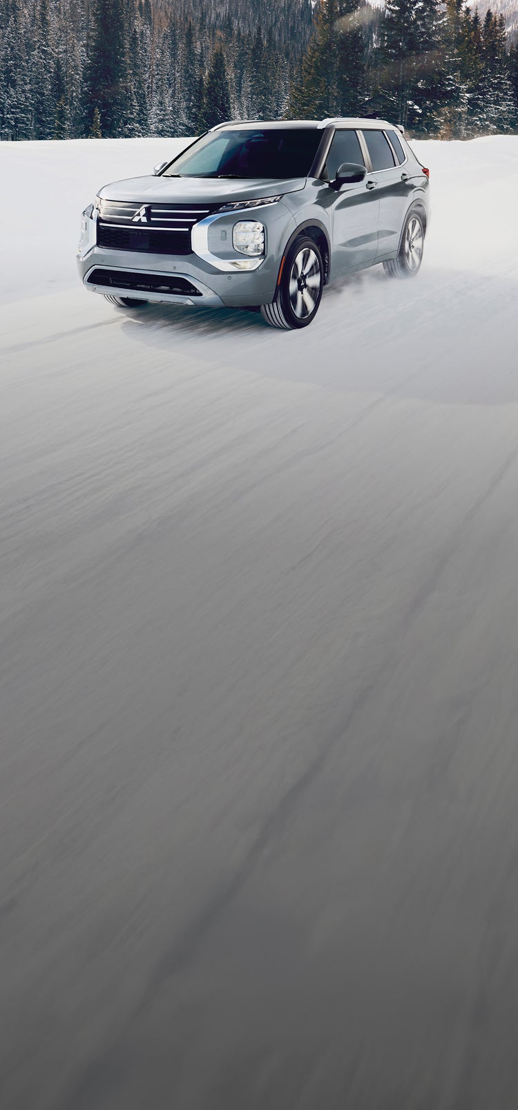 A silver 2025 Mitsubishi Outlander SUV in the snow