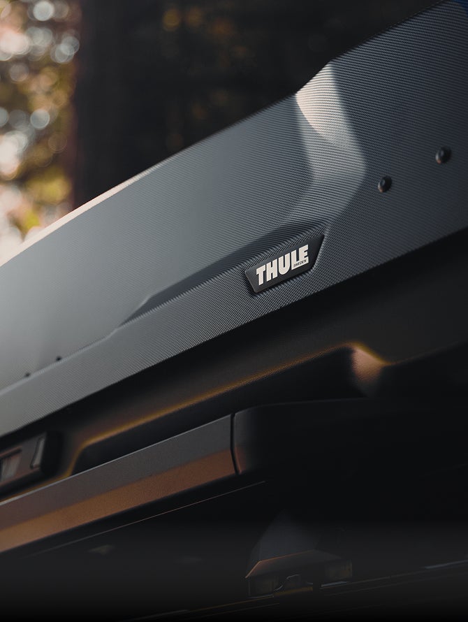 Close up on the THULE logo on a roof storage box installed on the 2026 Mitsubishi Outlander SUV Trail Edition