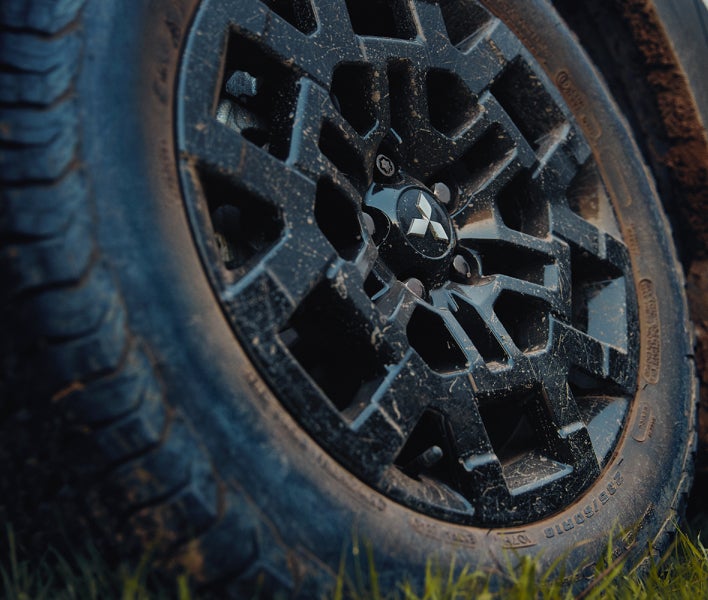 Close up on the 2026 Mitsubishi Outlander SUV Trail Edition exclusive black alloy wheels