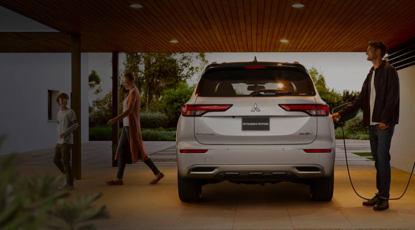 Mitsubishi Outlander Plug-in Hybrid SUV being charged in a garage